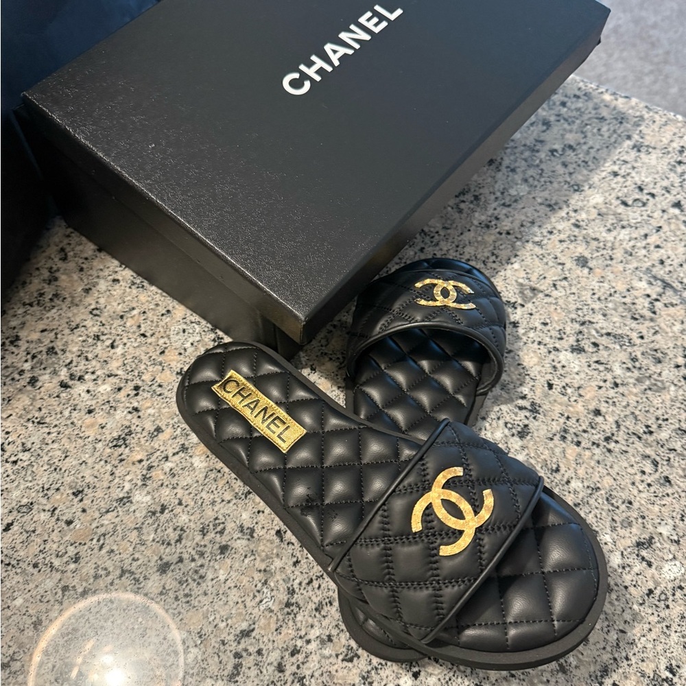 CHANEL Black Quilted Slides with Gold Accents